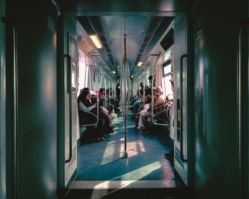 People sitting and standing in a modern train commuting